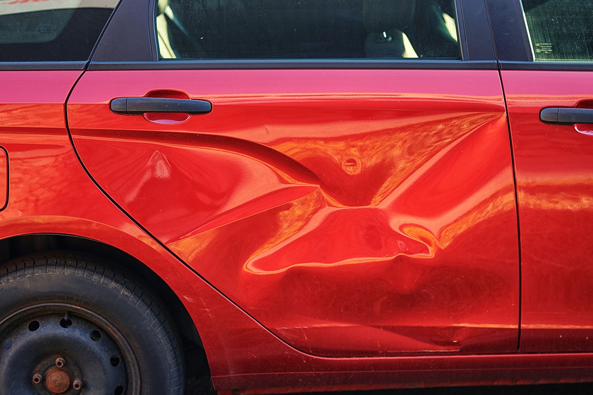 Dent on Red Car